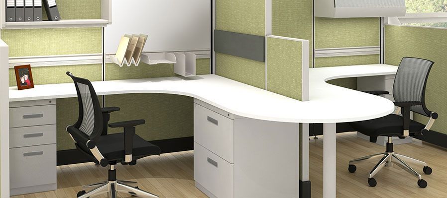 An office cubicle with two desks and two chairs