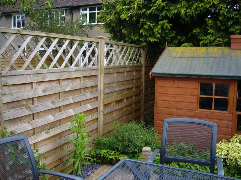 Urban Paving Bristol | A wooden shed is behind a wooden fence in a backyard