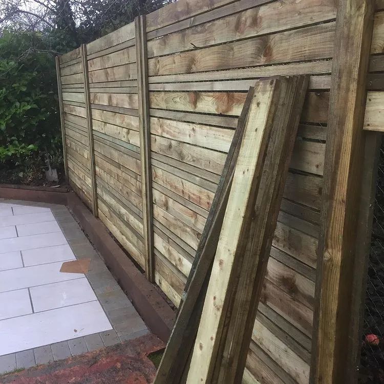 Urban Paving Bristol | A wooden fence is being built in a garden.