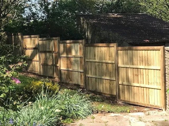 Urban Paving Bristol | A wooden fence surrounds a shed in a garden.