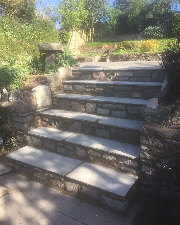 Urban Paving Bristol | A set of stone stairs leading up to a lush green hillside.