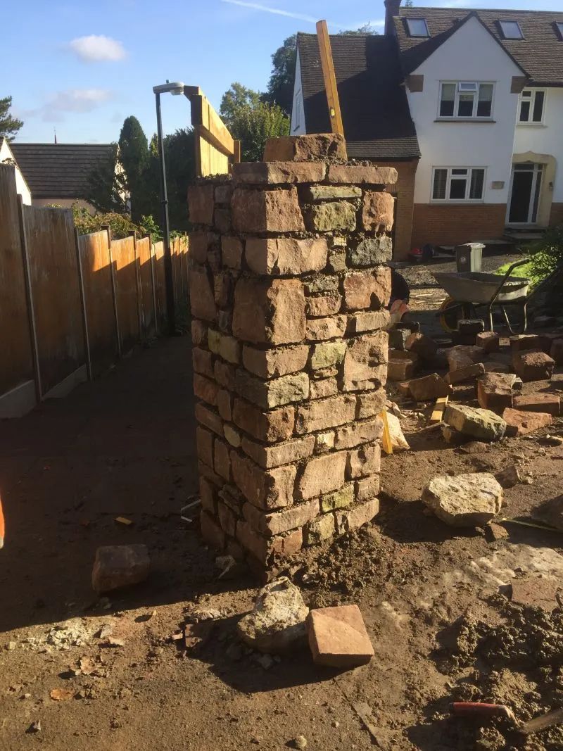 Urban Paving Bristol | A brick chimney is being built in a backyard.