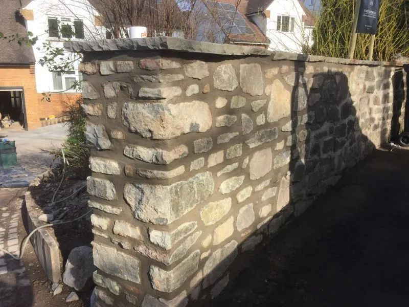 Urban Paving Bristol | A stone wall is being built in front of a house