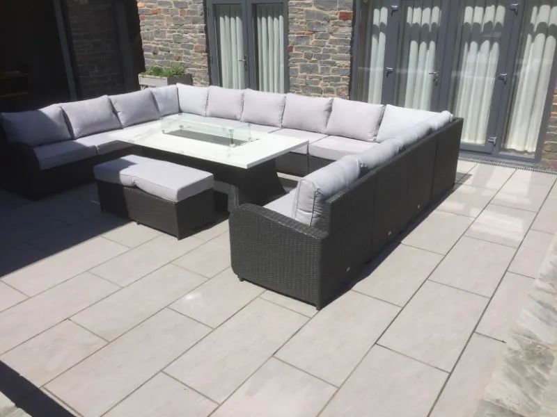 Urban Paving Bristol | A patio with a large sectional couch and a table