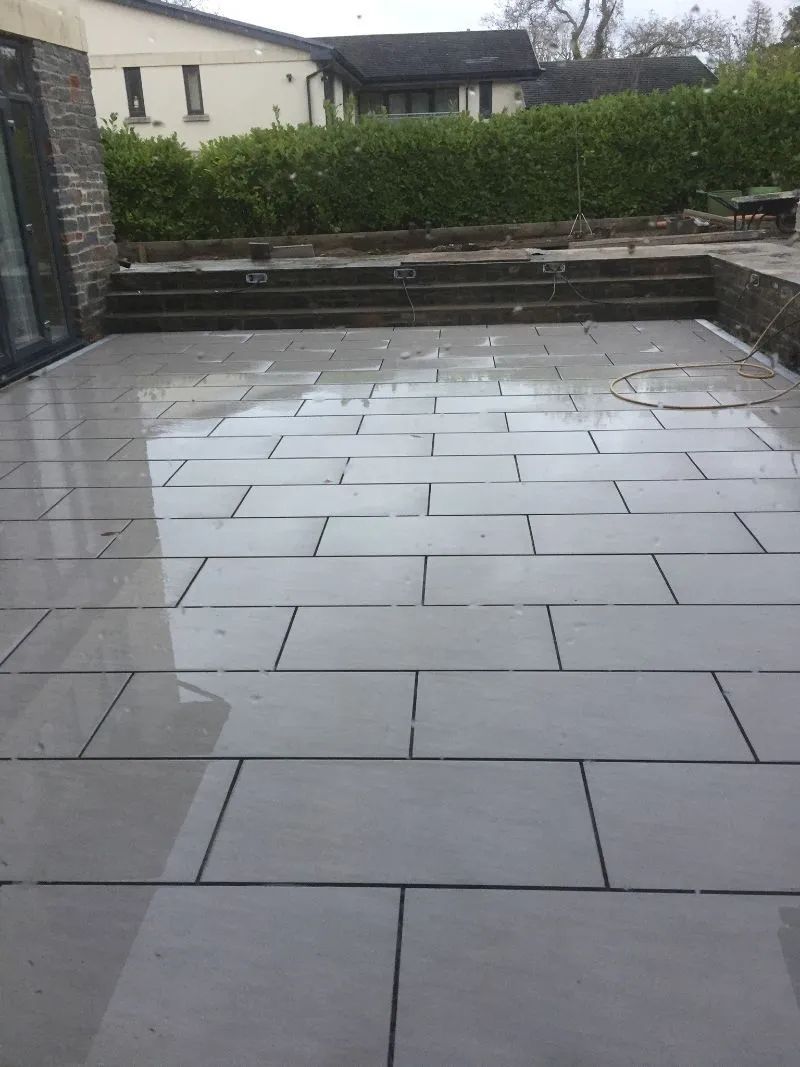 Urban Paving Bristol | A patio with a lot of tiles on it and a house in the background.