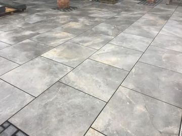 Urban Paving Bristol | A close up of a patio with gray tiles on it.