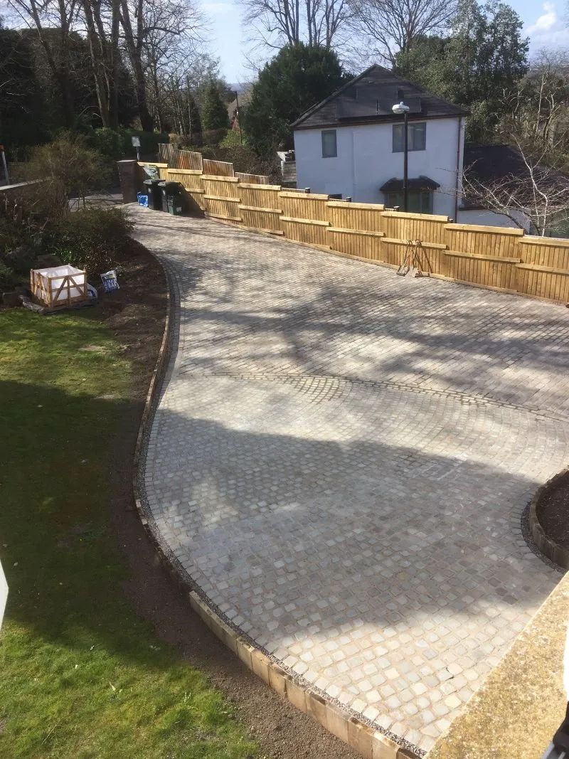 Urban Paving Bristol | A concrete driveway is being built in front of a house.