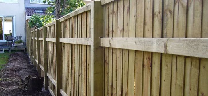 Urban Paving Bristol | A wooden fence is being built in the backyard of a house.