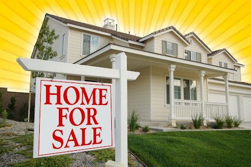 A house with a home for sale sign in front of it