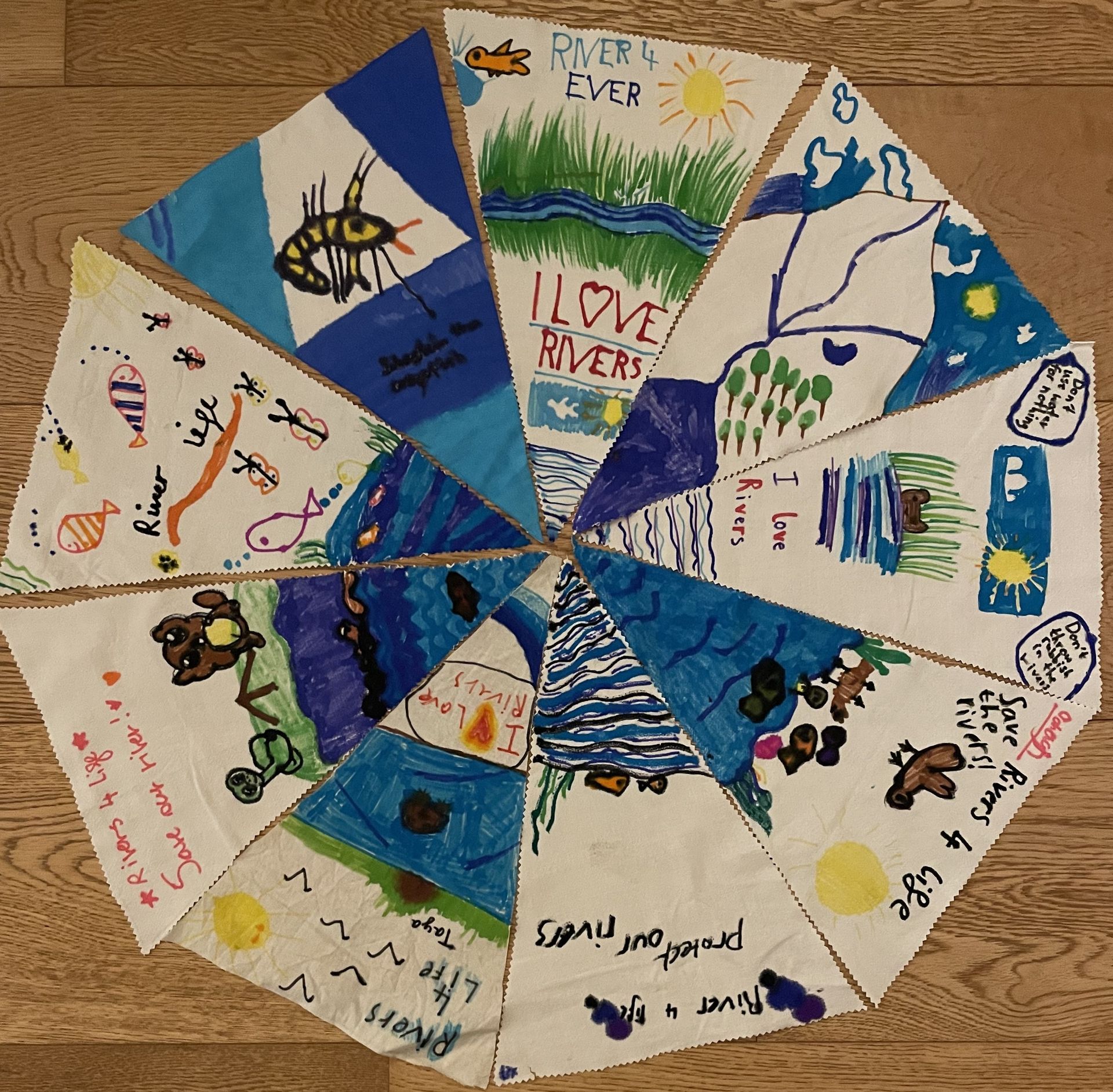 Sections of bunting created by primary school children all put together to make a circle.