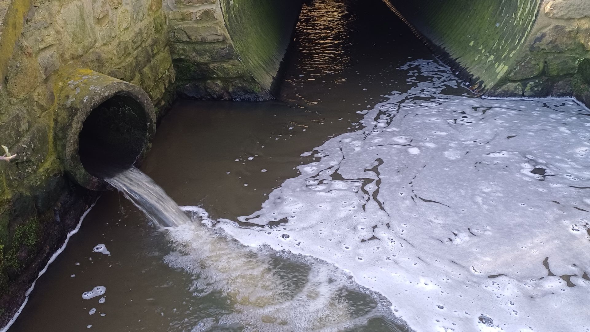 an combined sewer outfall dispensing water into a stream