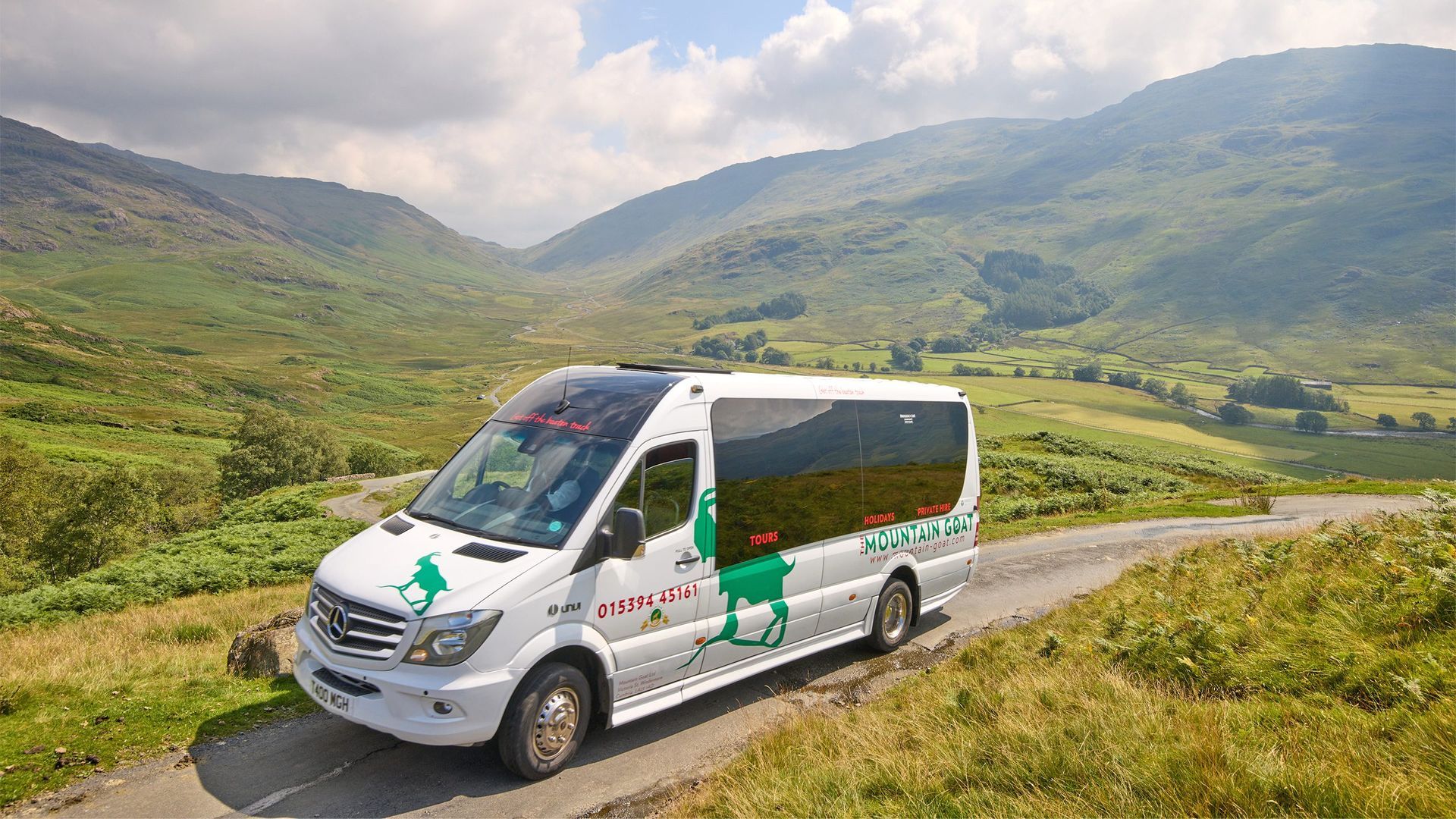 Minibus in a hilly rural setting.