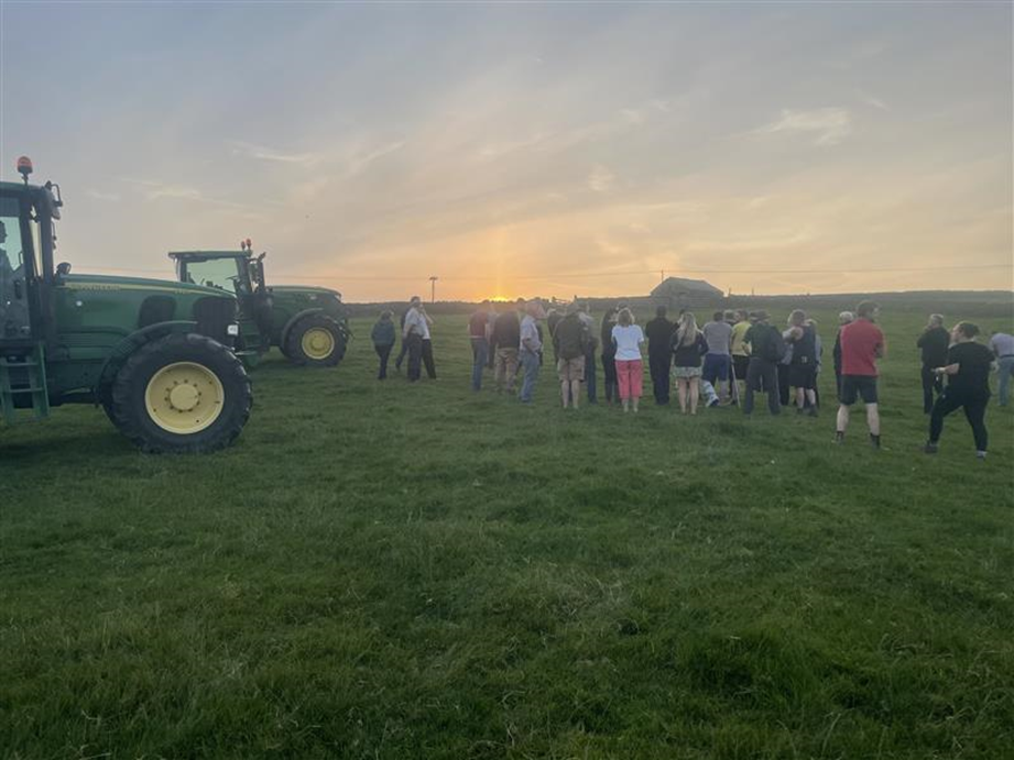 Tractor and people in field