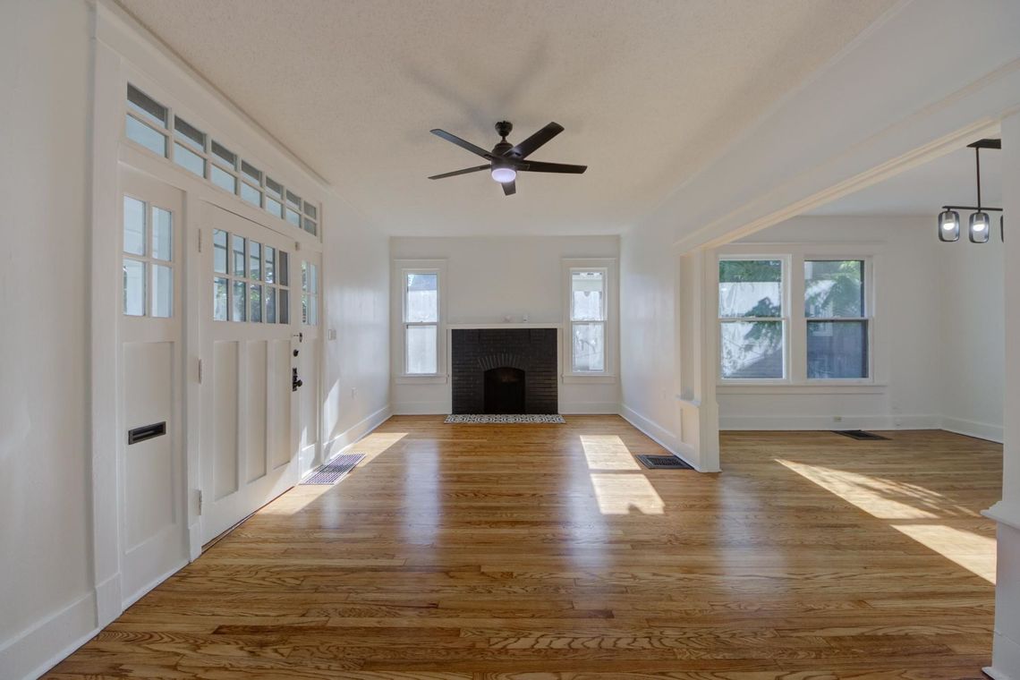 Bright open sitting area, wood burning fireplace open to dinning and kitchen.