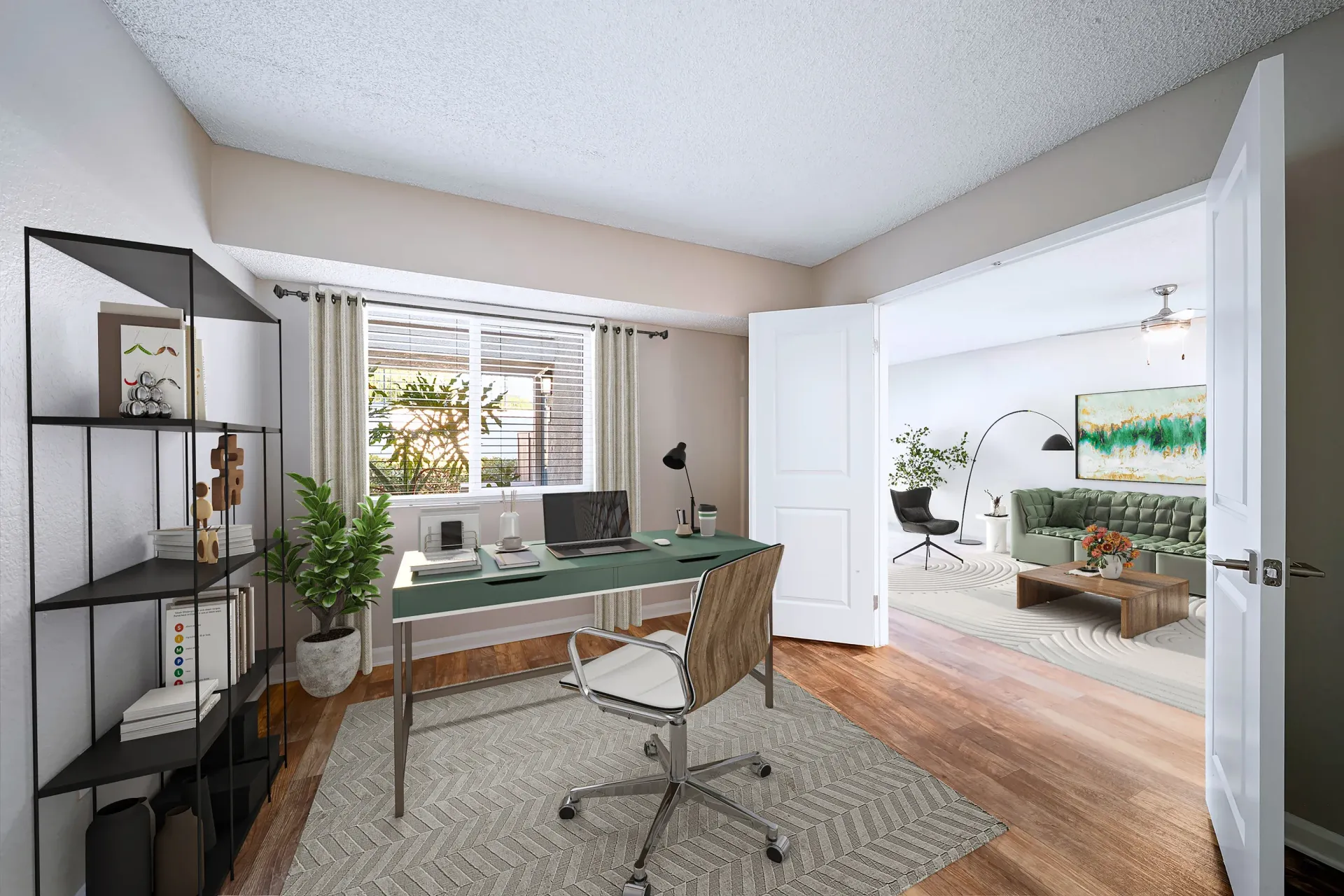 Home office corner in an apartment with desk, laptop, and view into the living room at Sonora at Alta Loma apartments in Alta Loma, CA.