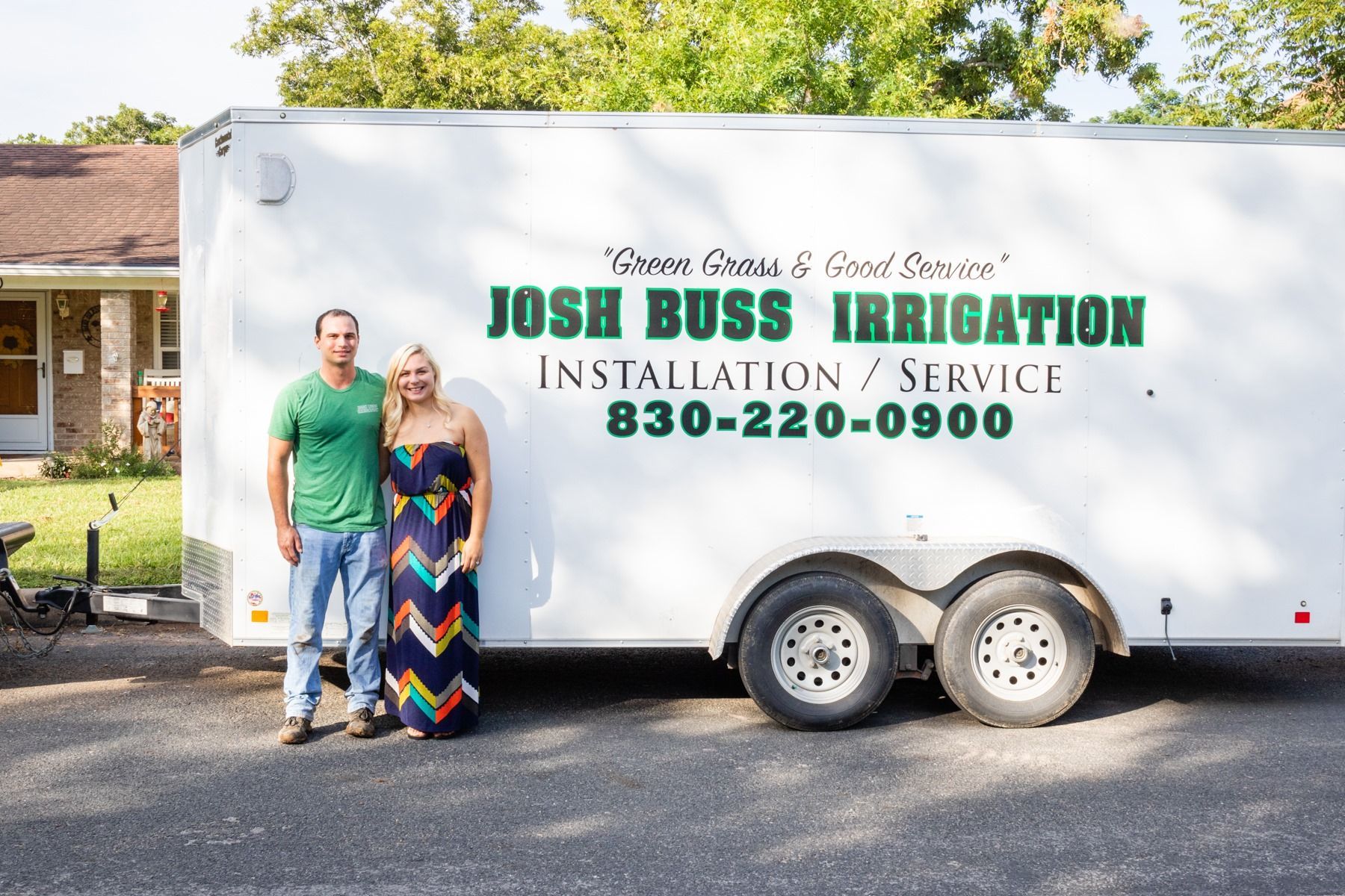 Josh Buss Irrigation service truck with two people standing in front of it