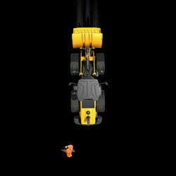 A loader backing up quickly about to hit an unaware worker.