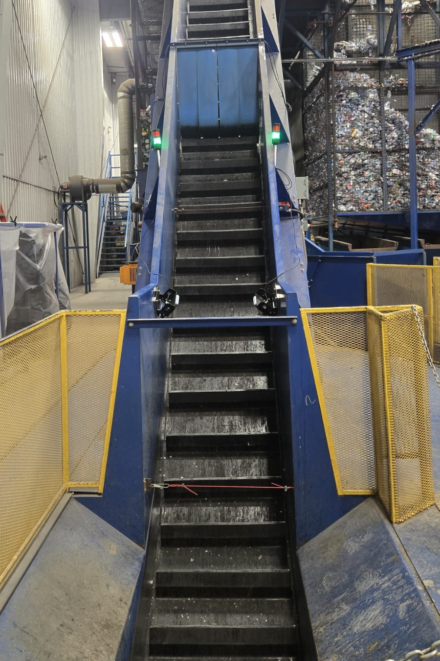 Black conveyor belt in an industrial facility, equipped with SCAN~LINK system