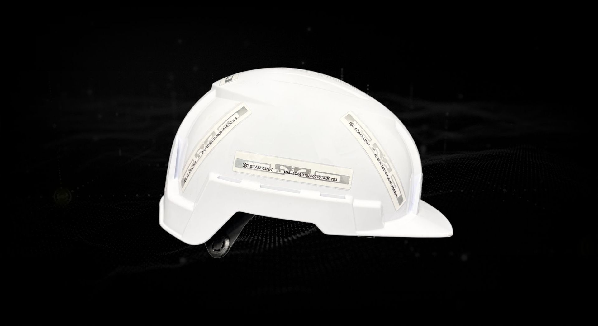 A white hard hat shown side view on a black background with RFID tags on it