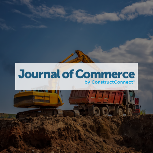 Journal of Commerce logo over a construction site; heavy machinery, dirt, and a cloudy sky.