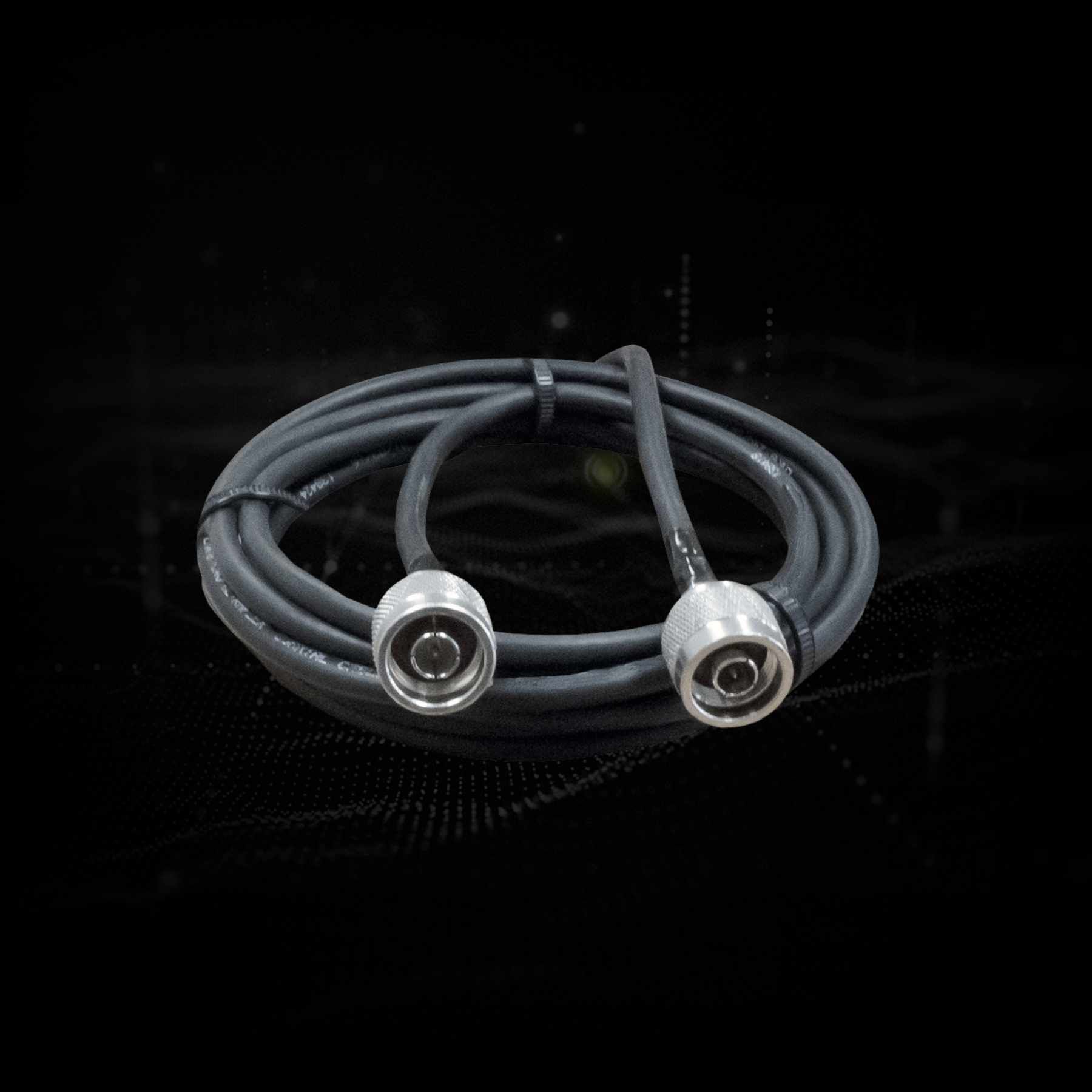 Coiled RF cable with two silver connectors on a dark background