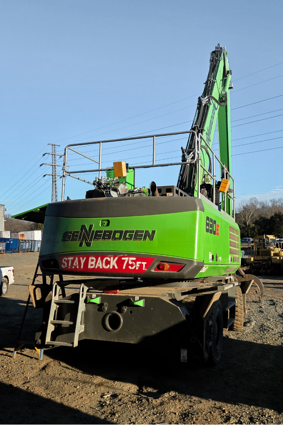 Green Sennebogen excavator at a construction site, equipped with SCAN~LINK Antenna