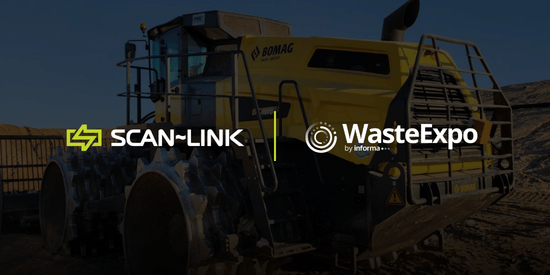 Yellow construction vehicle with SCAN-LINK and CONEXPO-CON/AGG logos in an industrial yard