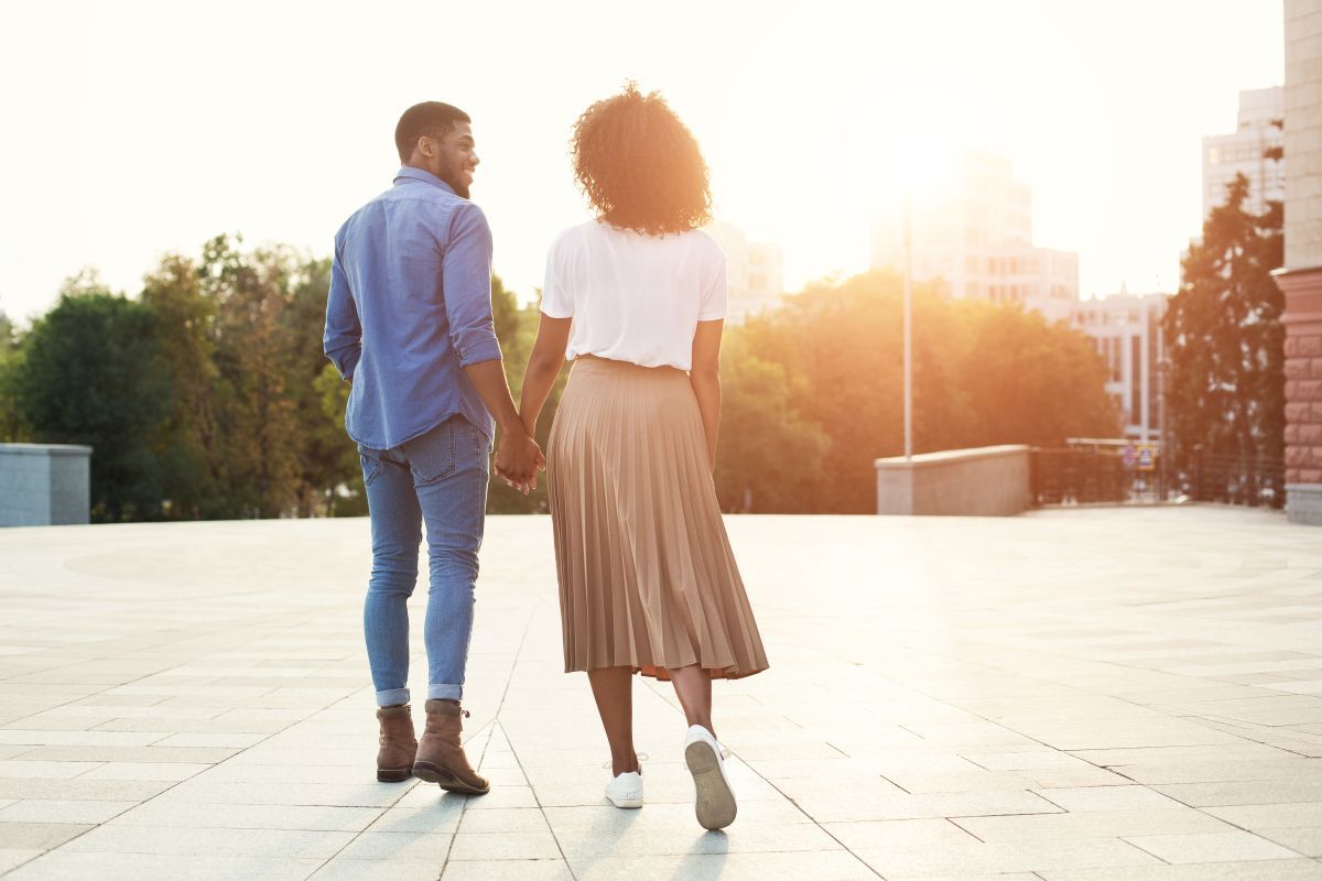 White elderly couple embracing each other at the park