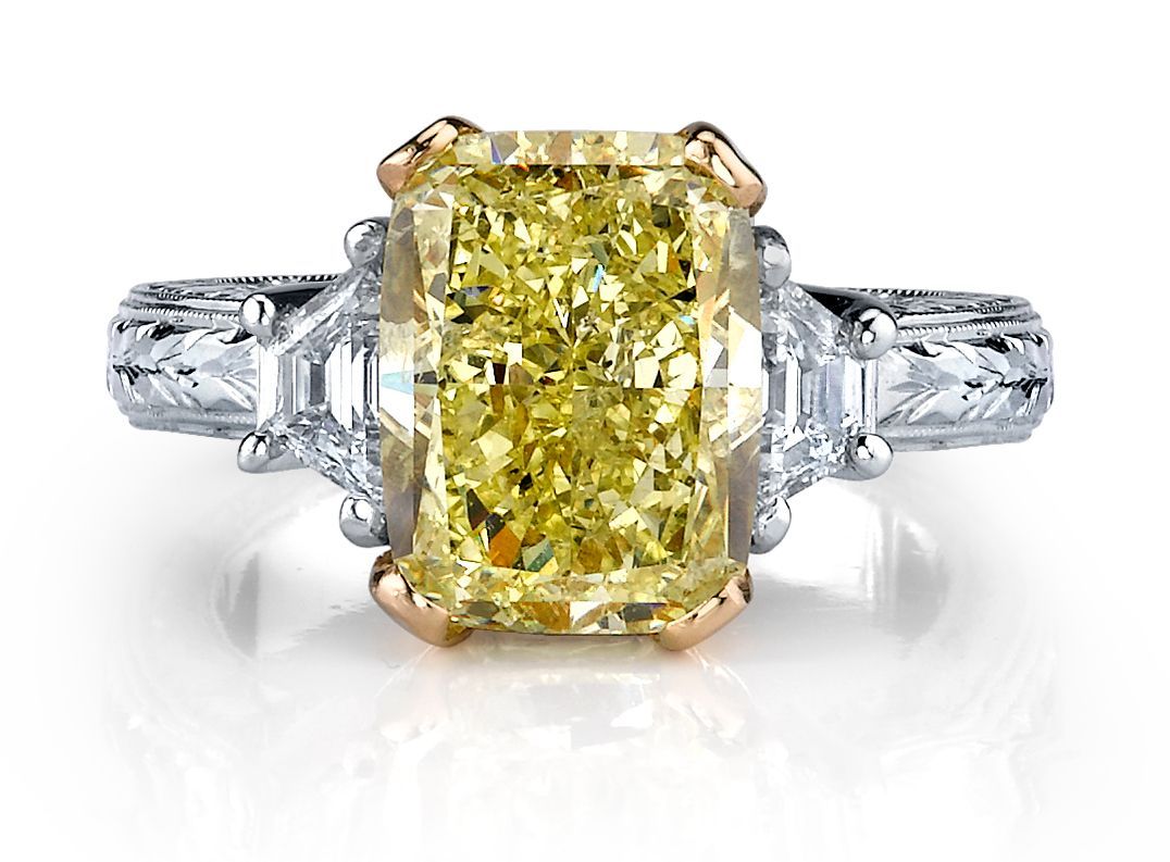 Hand with stacked diamond rings and a large square-cut diamond ring.