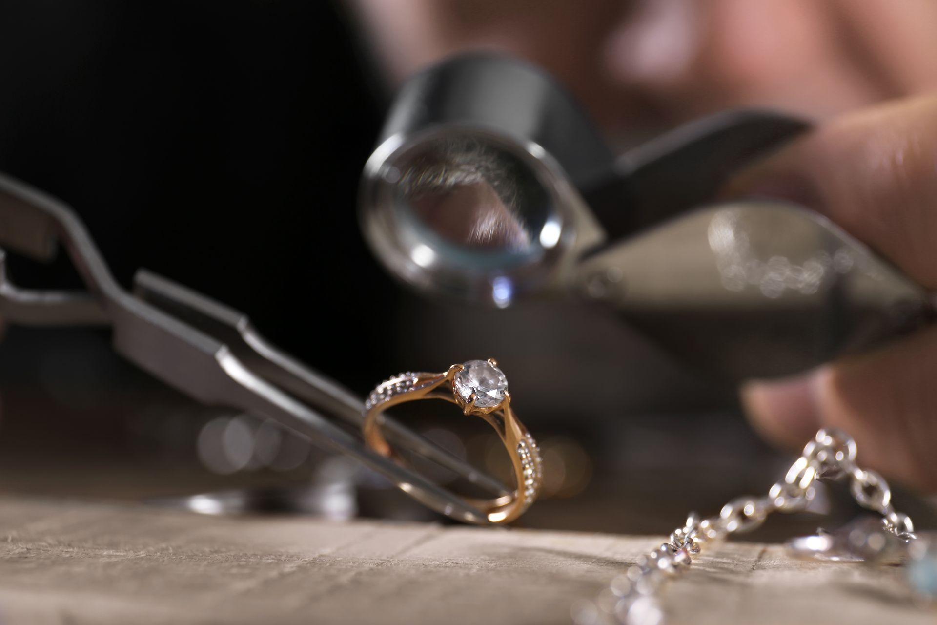 Silver diamond ring with a large square-cut center stone on a display stand