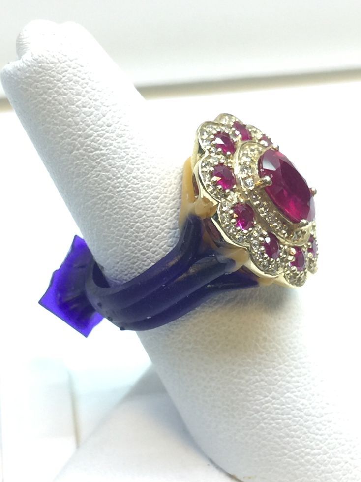 Silver diamond ring with a large square-cut center stone on a display stand