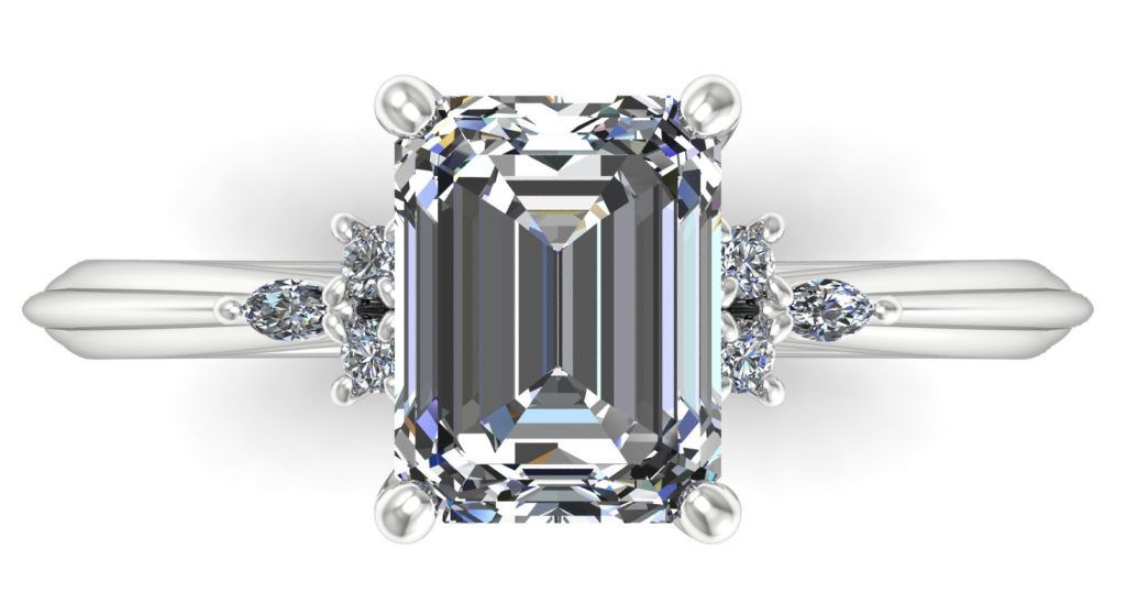 Emerald-cut diamond engagement ring with side stones on a white background