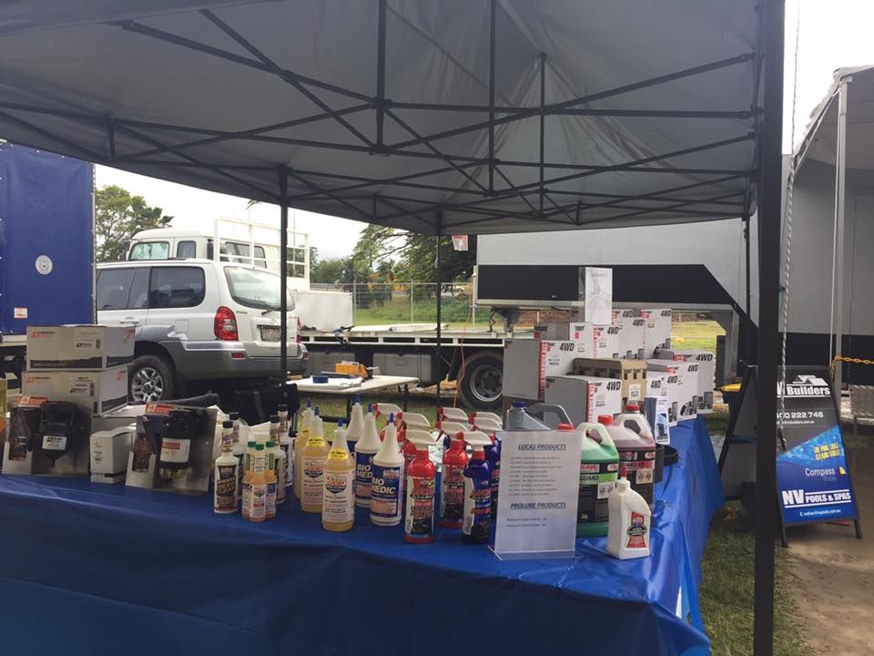 A Table With Bottles Of Cleaning Supplies On It Under A Tent — Filta-Wash Mackay In North Mackay, QLD