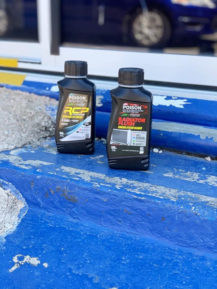 Two Bottles Of Oil Are Sitting On A Blue Surface — Filta-Wash Mackay In North Mackay, QLD