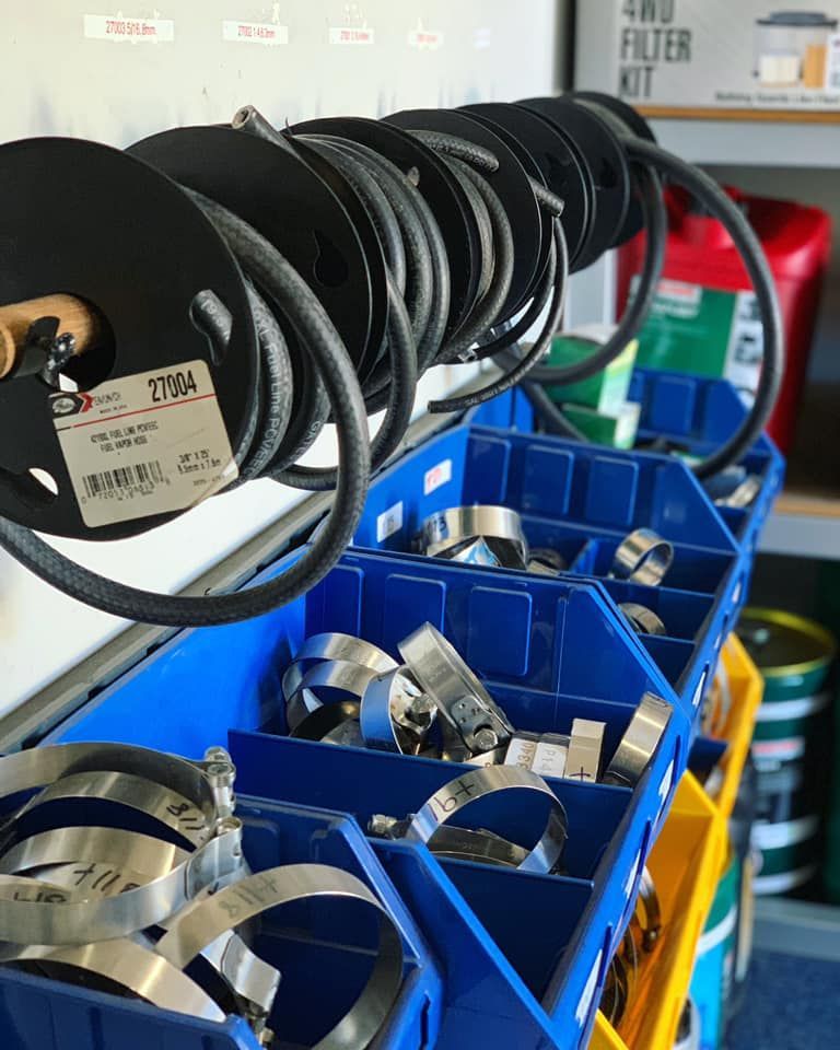 A Bunch Of Spools Of Hose Hanging On A Rack — Filta-Wash Mackay In North Mackay, QLD