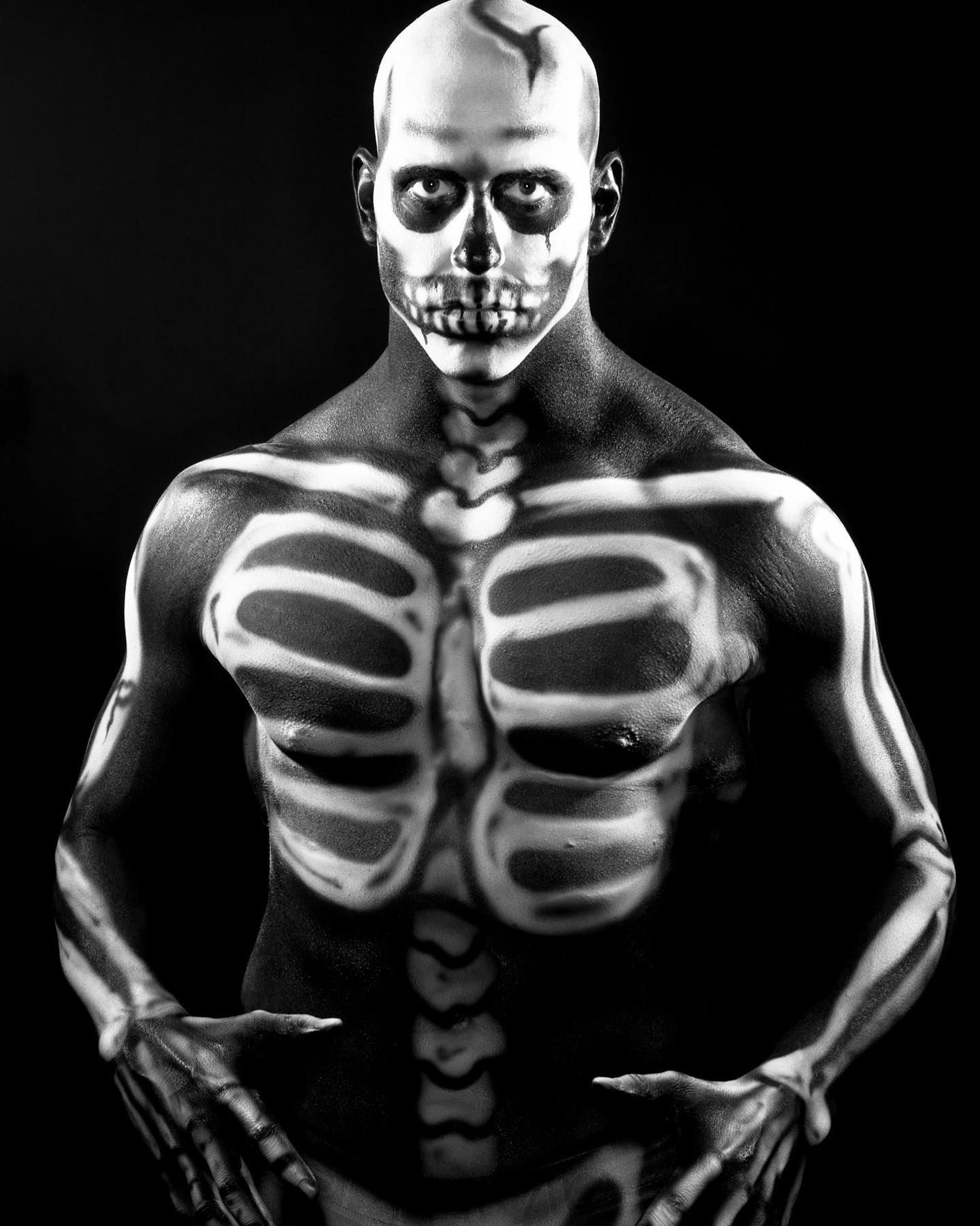 A man with his body painted like a skeleton