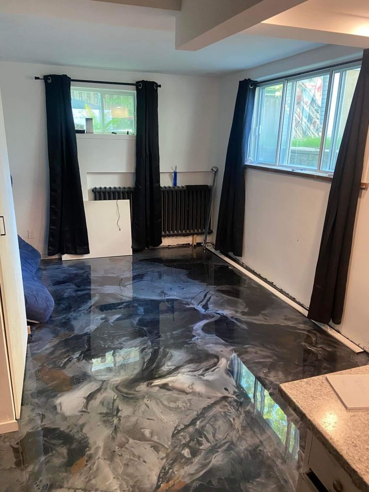 A living room with a marble floor and black curtains.