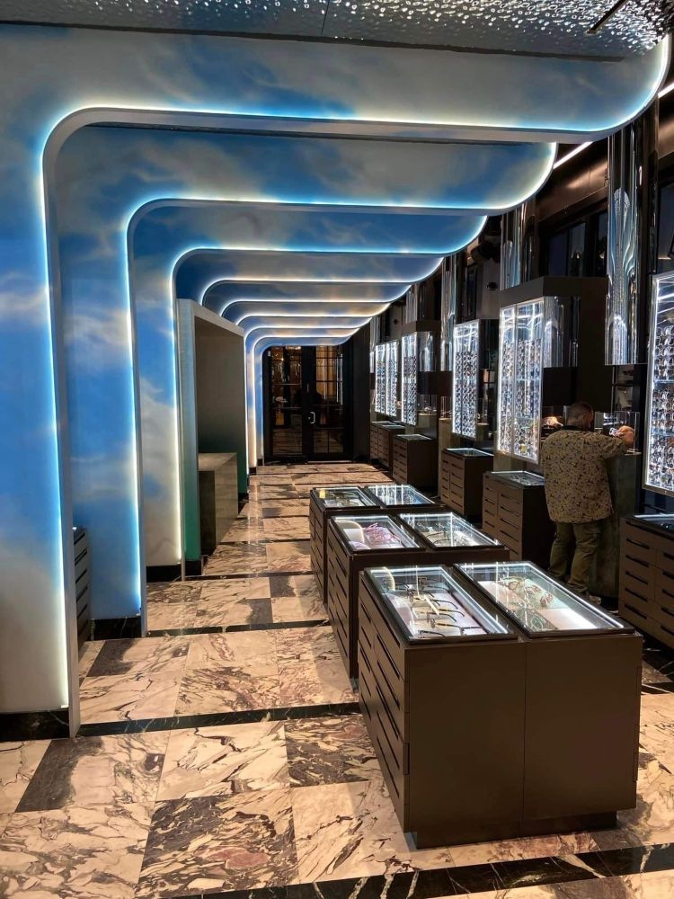 A long hallway with a blue sky painted on the ceiling.