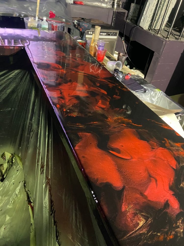 A fish tank with a lot of fish swimming in it.