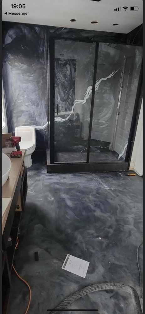 A bathroom with a toilet , sink , and shower.