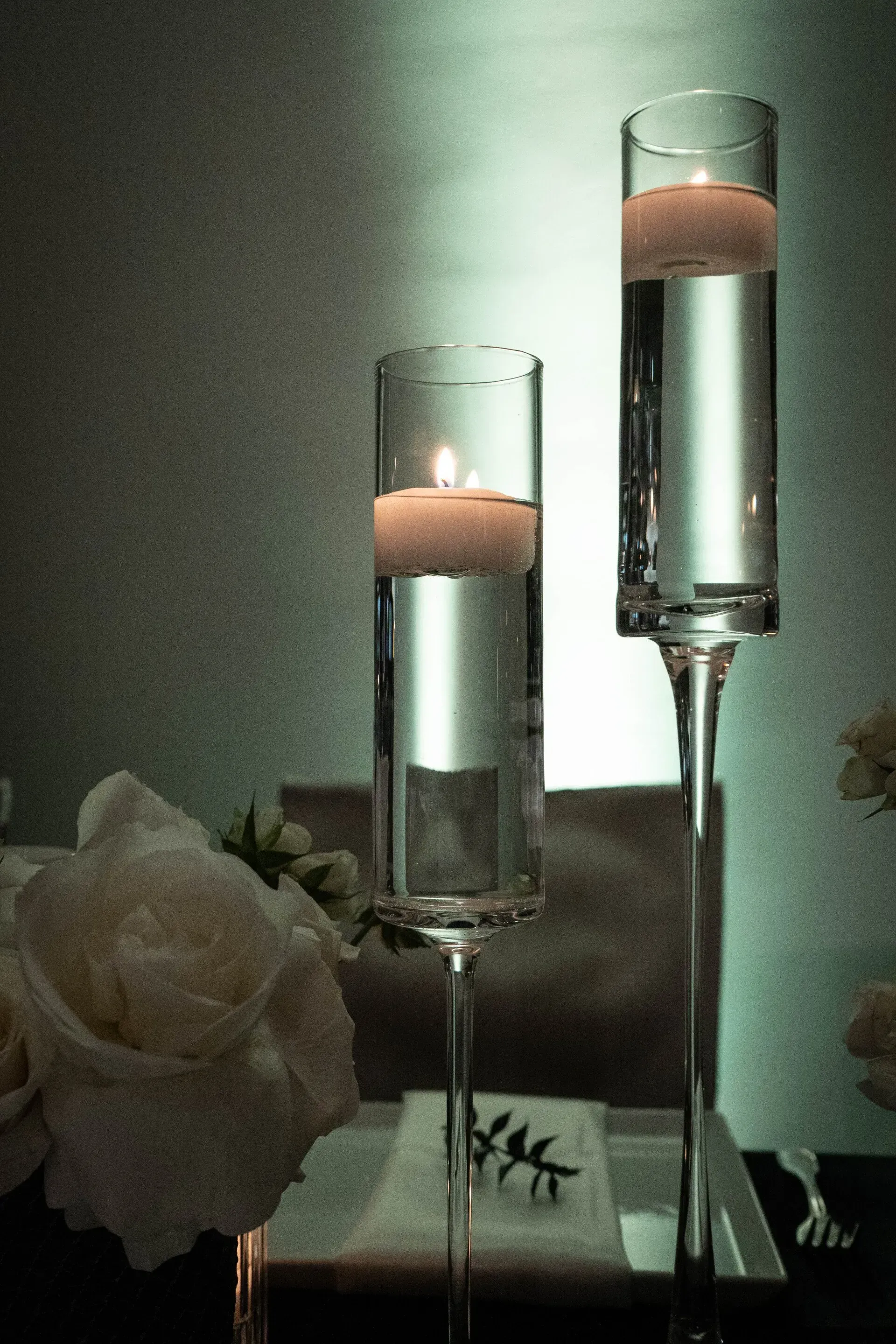 A couple of candles in glasses filled with water