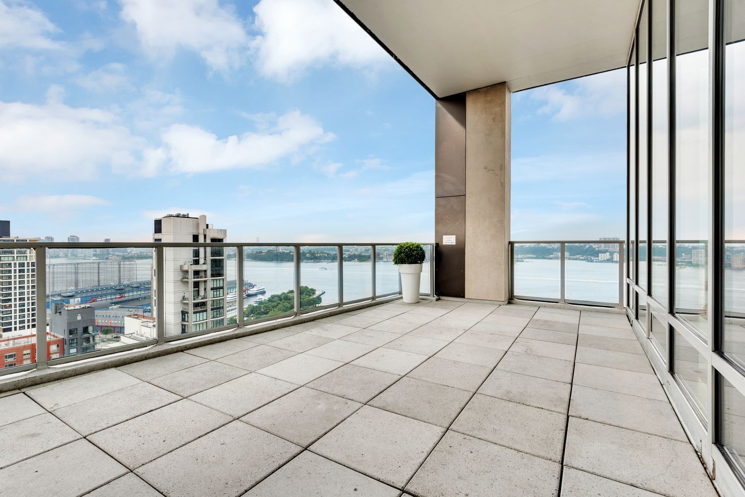 An empty balcony with a view of a body of water