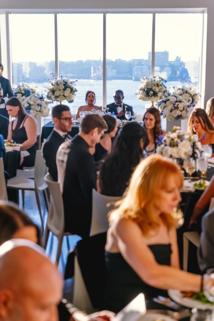 A group of people are sitting at tables at a wedding reception.