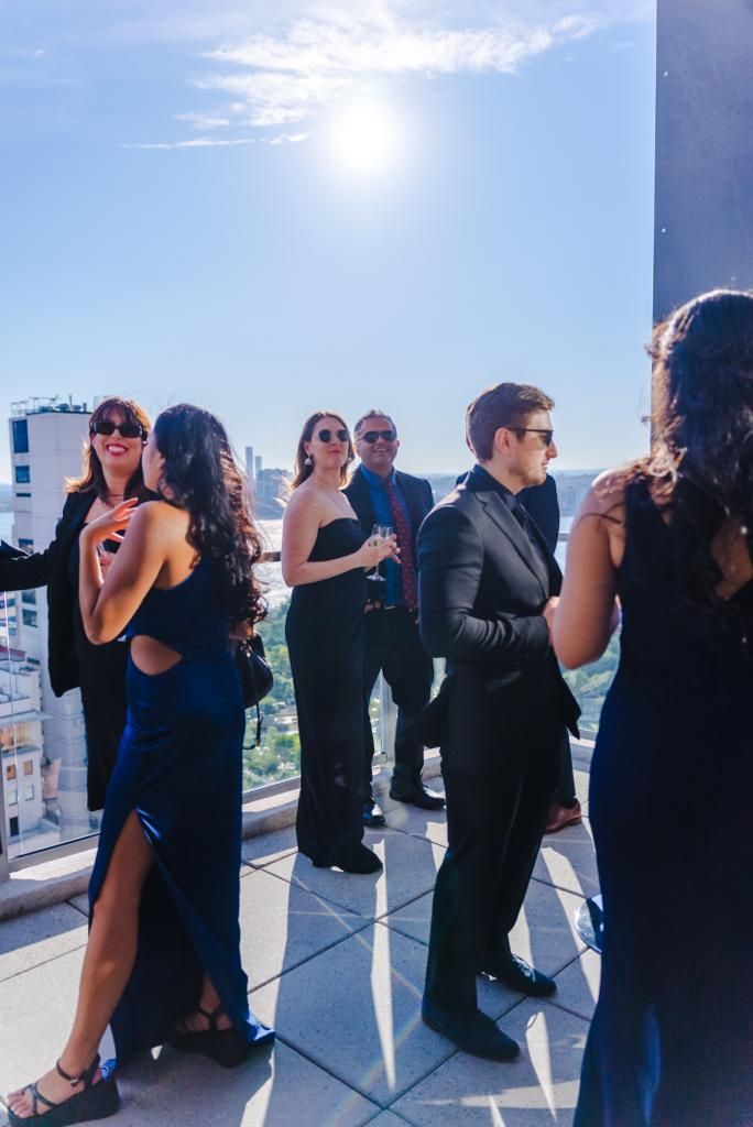 a group of people are standing on a balcony .