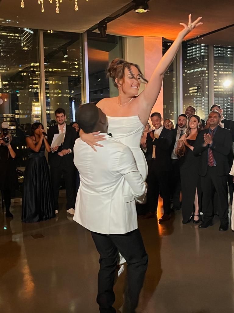 a bride and groom are dancing in front of a crowd