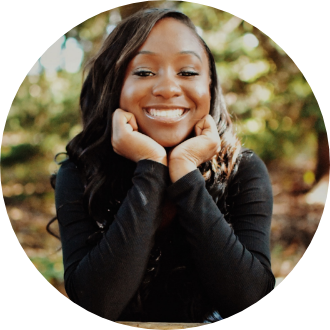 a woman in a black shirt is smiling with her hands on her face
