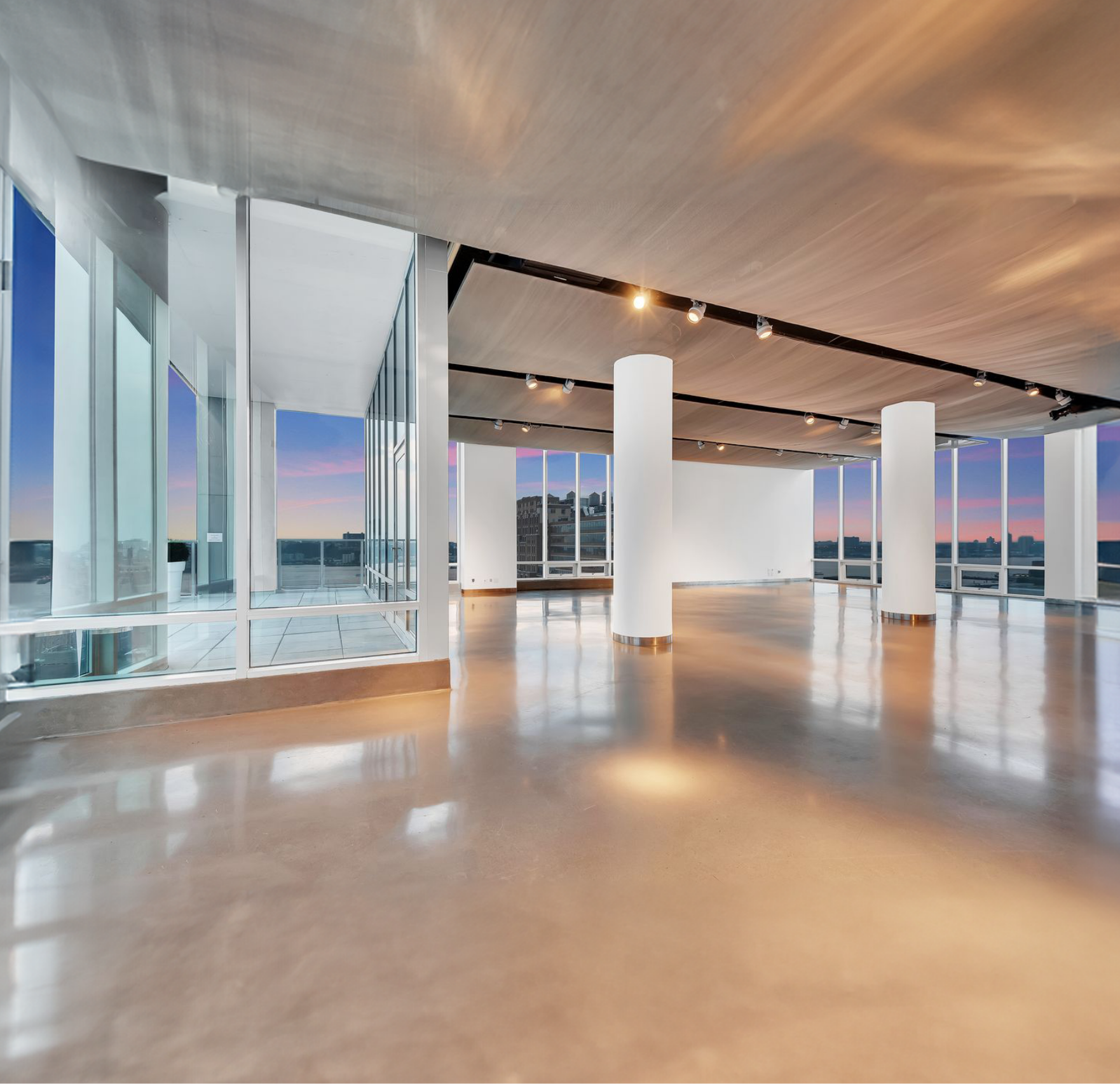 A large empty room with a lot of windows