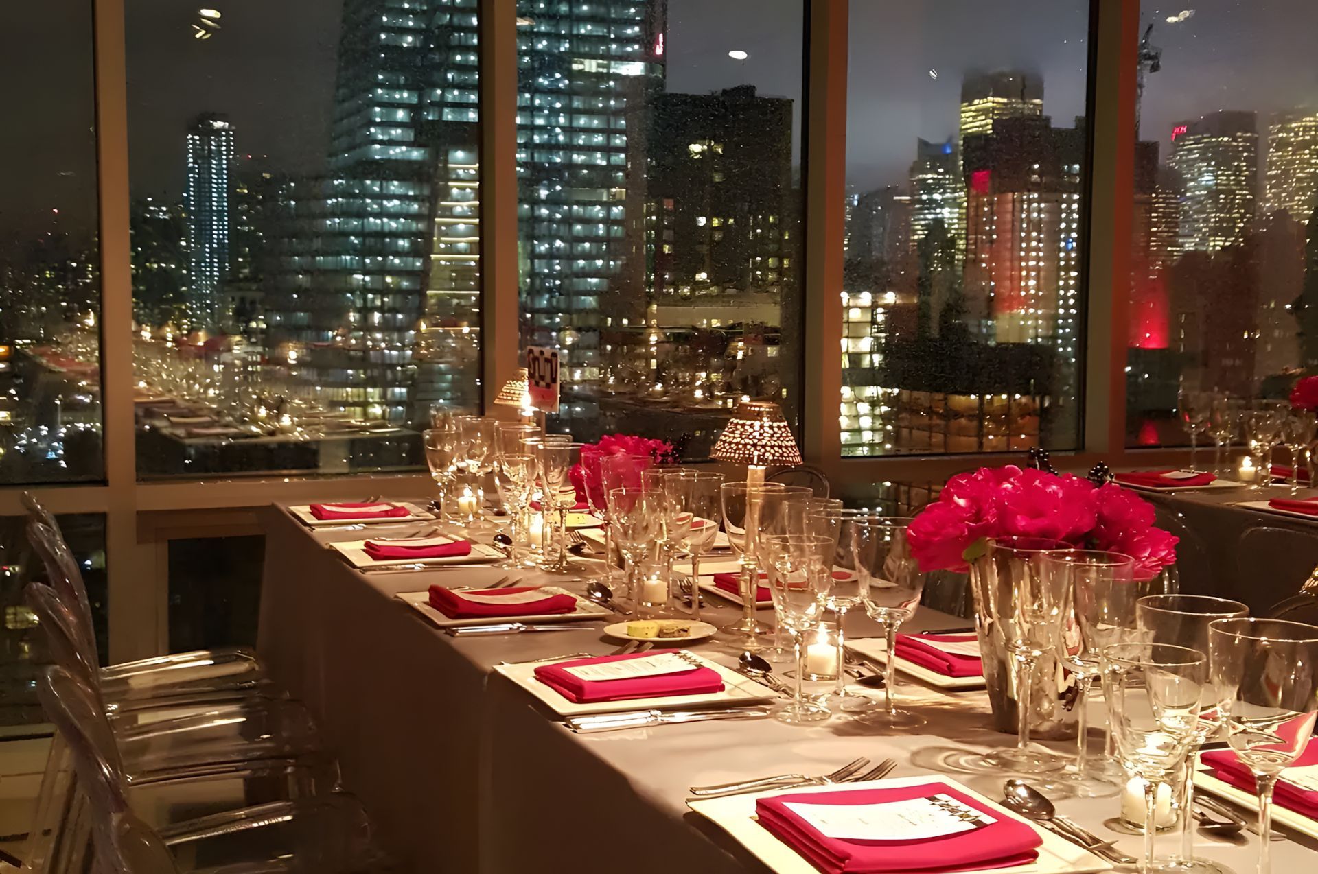 A long table with a view of the city at night