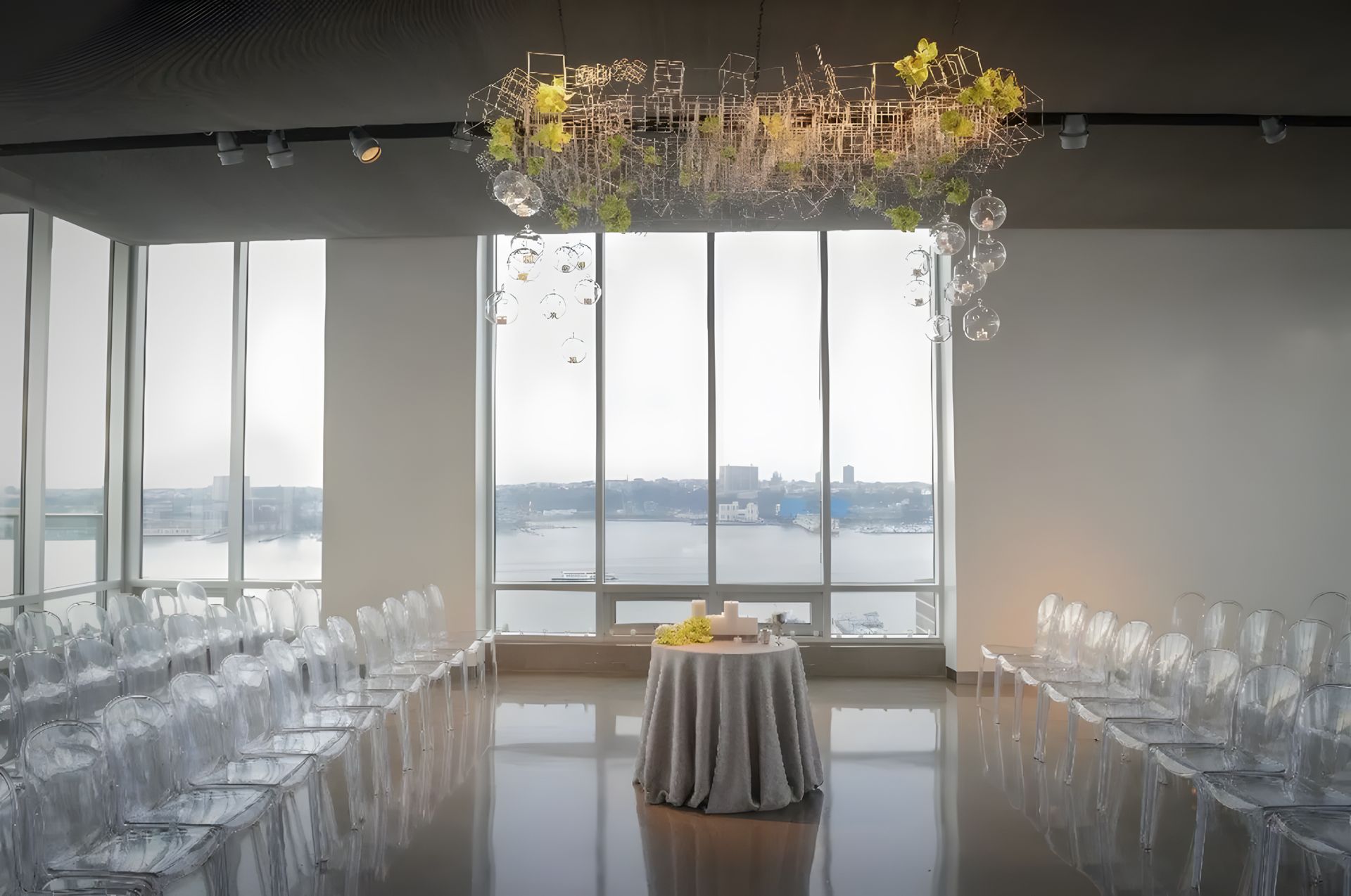 A large room with a table and chairs and a chandelier hanging from the ceiling
