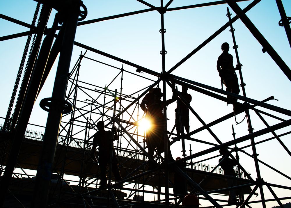 A Group of Construction Workers Are Working on a Scaffolding Structure — Byron Bay Scaffold in Lismore, NSW
